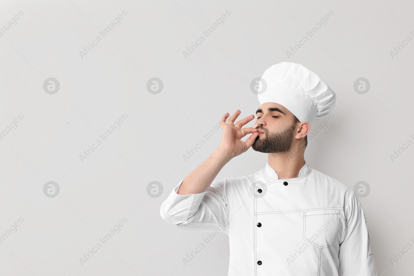 Photo of Professional chef showing perfect sign on white background