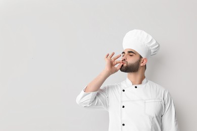Photo of Professional chef showing perfect sign on white background