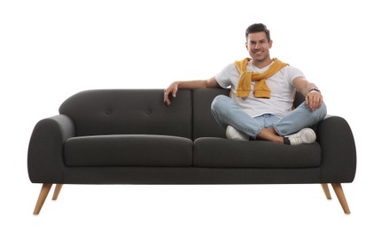Photo of Man relaxing on comfortable grey sofa against white background