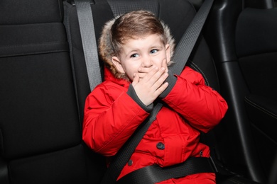Photo of Little boy suffering from nausea in car