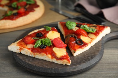 Photo of Slices of delicious pita pizza on wooden table