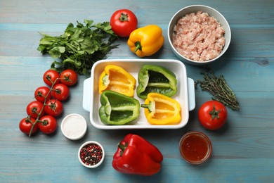 Photo of Making stuffed peppers. Vegetables and ground meat on light blue wooden table, flat lay