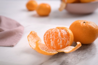 Photo of Fresh tangerines on marble board. Citrus fruit
