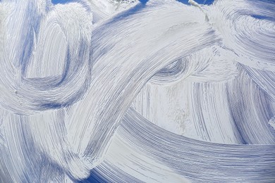 Cleaning foam on window glass, closeup view