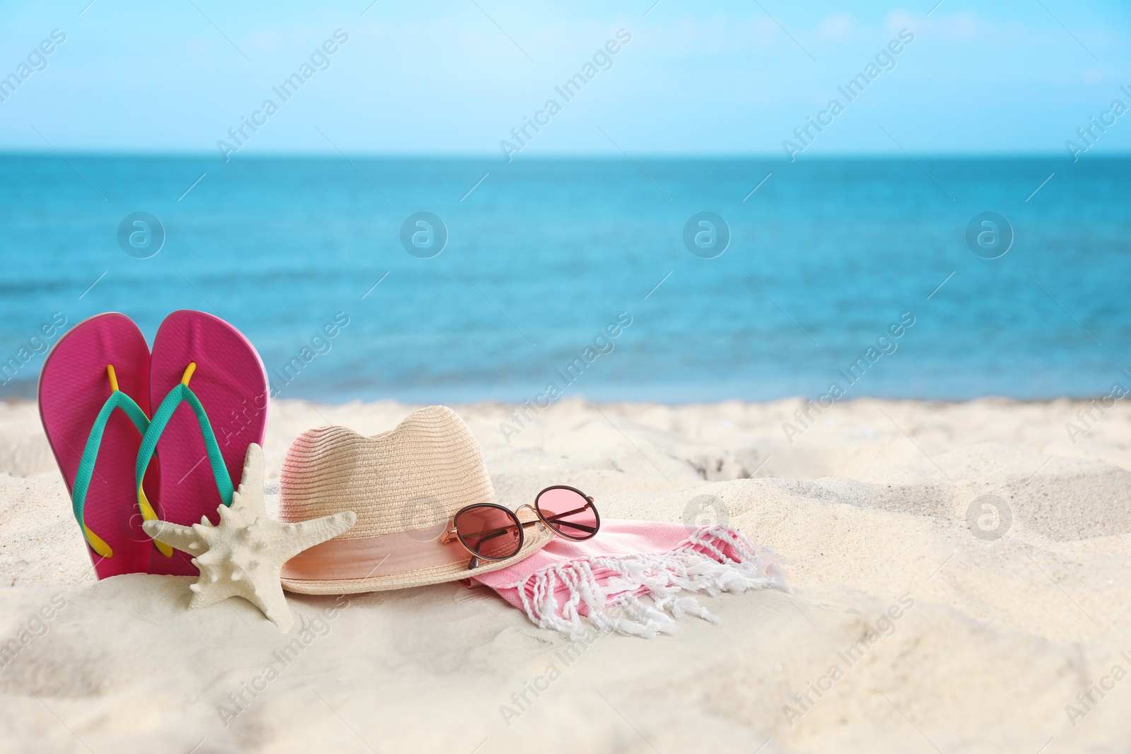 Image of Accessories on sunny ocean beach, space for text. Summer vacation