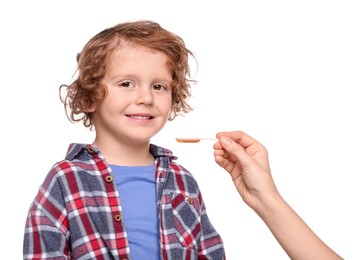 Photo of Mother giving cough syrup to her son against white background, closeup