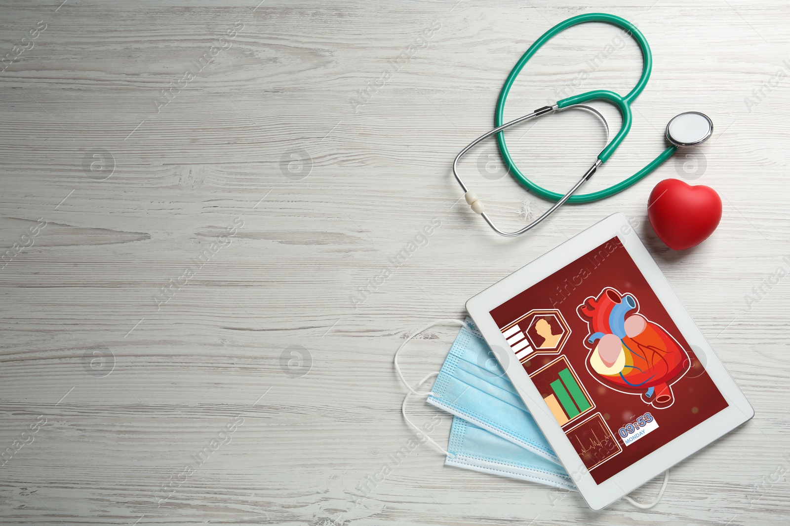 Photo of Flat lay composition with tablet and red heart on white wooden table, space for text. Cardiology concept