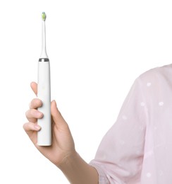 Photo of Woman holding electric toothbrush on white background, closeup