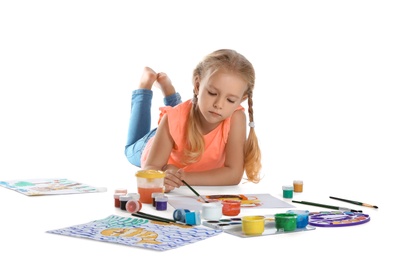 Photo of Cute child painting picture on white background