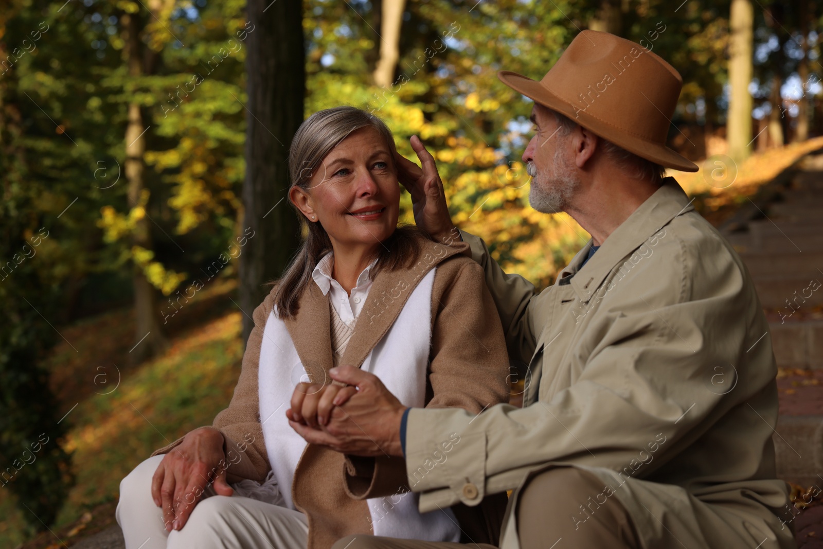 Photo of Affectionate senior couple spending time together in autumn park