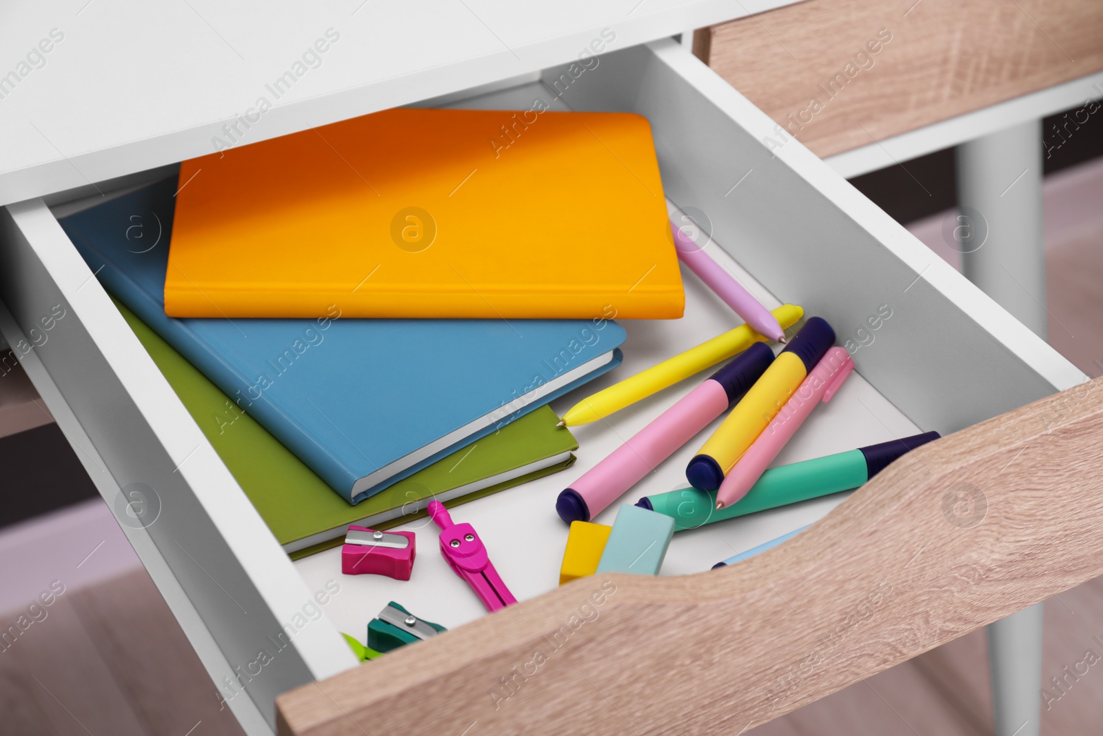 Photo of Office supplies in open desk drawer indoors, closeup