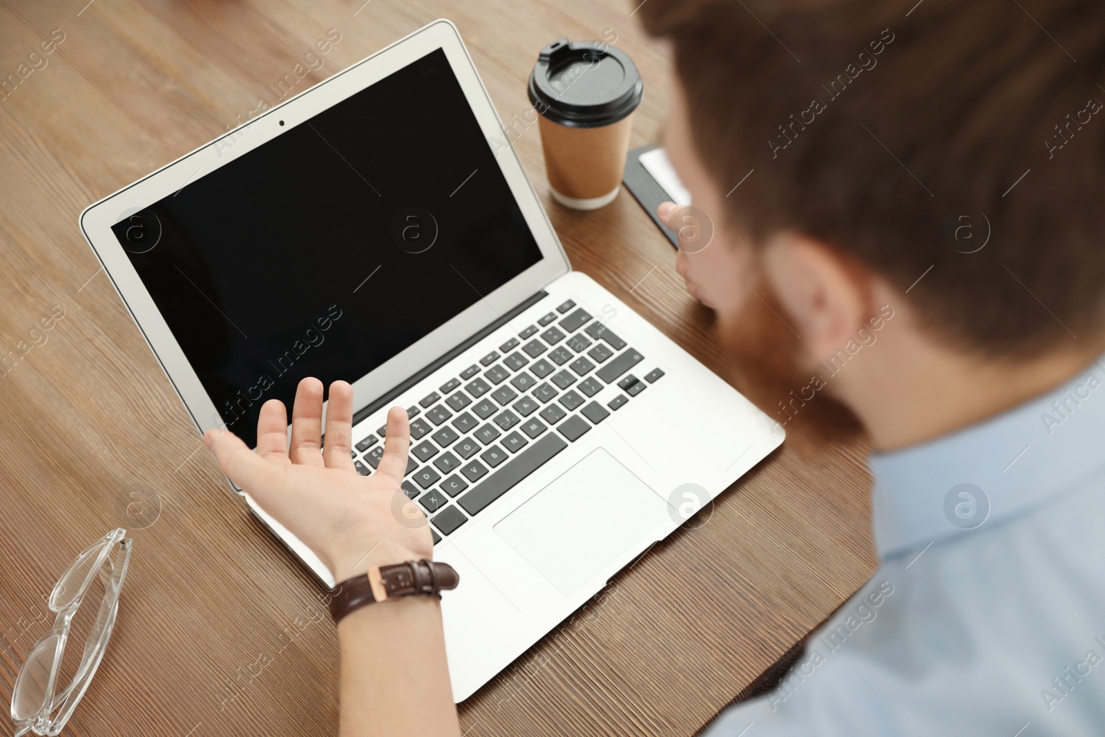 Photo of Man using video chat on laptop in home office, closeup. Space for text