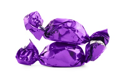 Photo of Candies in purple wrappers isolated on white