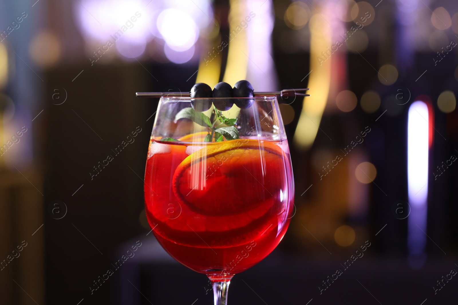 Photo of Glass of delicious refreshing sangria on blurred background, closeup