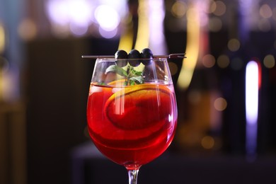 Glass of delicious refreshing sangria on blurred background, closeup