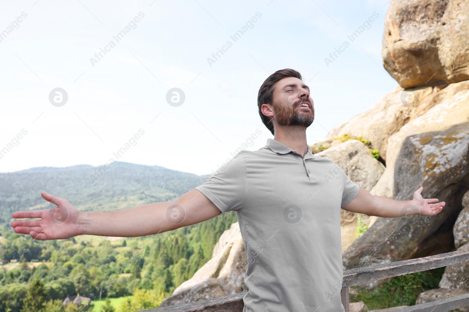 Photo of Feeling freedom. Man with wide open arms in mountains