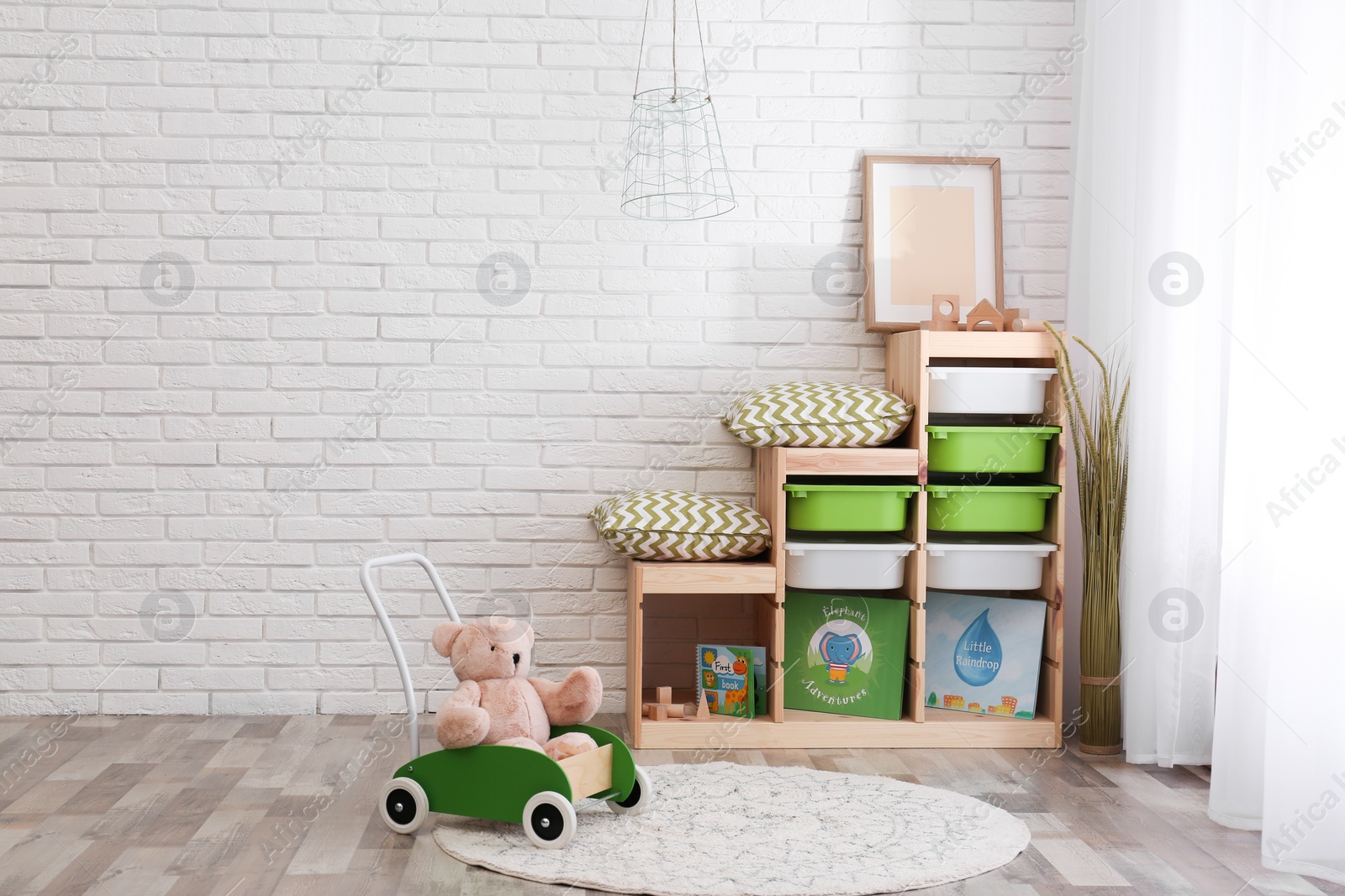 Photo of Modern eco style interior of child room with wooden crates near brick wall. Space for text