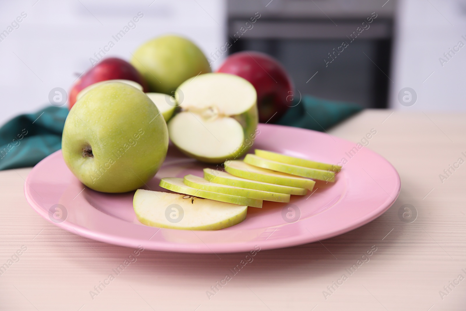 Photo of Plate with ripe apples on kitchen table