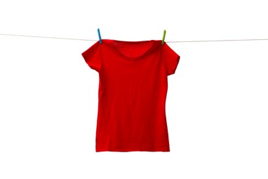 One red t-shirt drying on washing line isolated on white