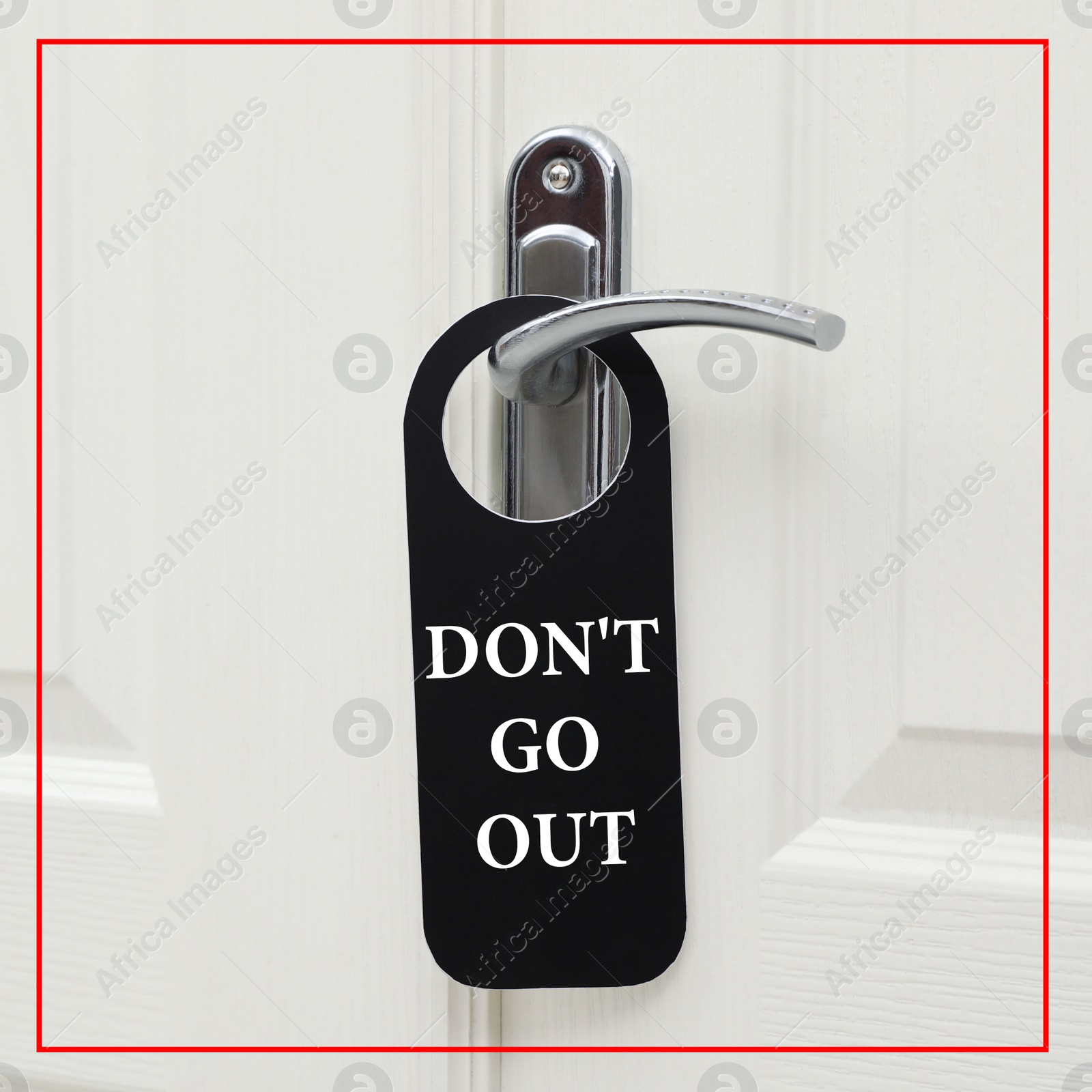 Image of Closed door with sign DON'T GO OUT on handle. Stay at home during coronavirus quarantine