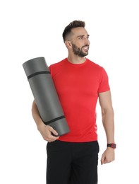 Handsome man with yoga mat on white background