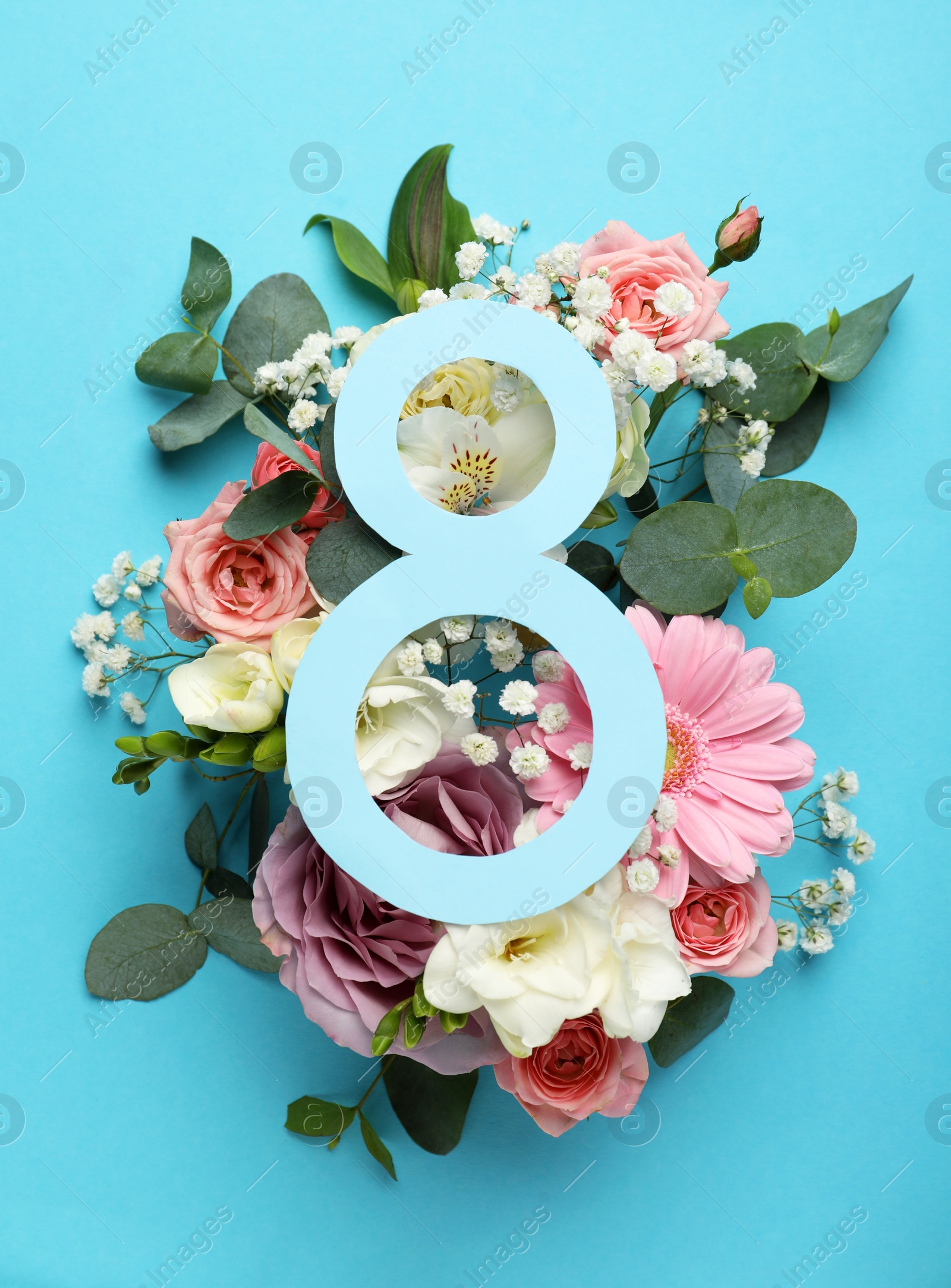 Photo of 8 March greeting card design with beautiful flowers on light blue background, flat lay. International Women's day