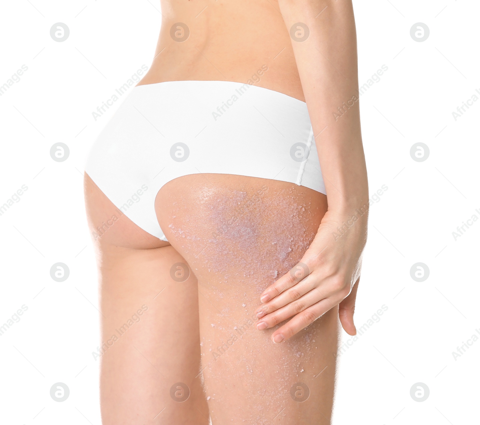 Photo of Young woman applying natural scrub on her body against white background