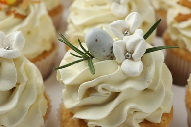 Tasty Easter cupcakes with vanilla cream, closeup