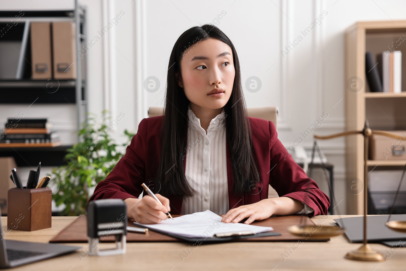 Photo of Portrait of notary at table in office