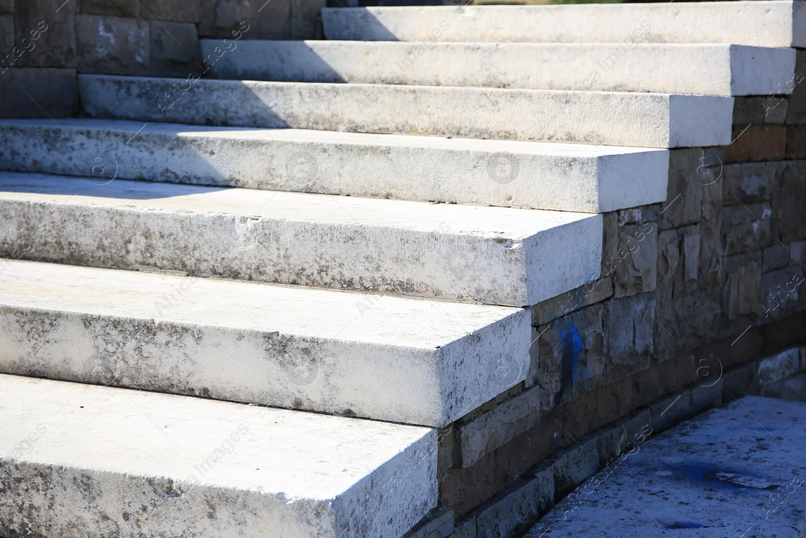 Photo of View of empty old concrete staircase outdoors on sunny day