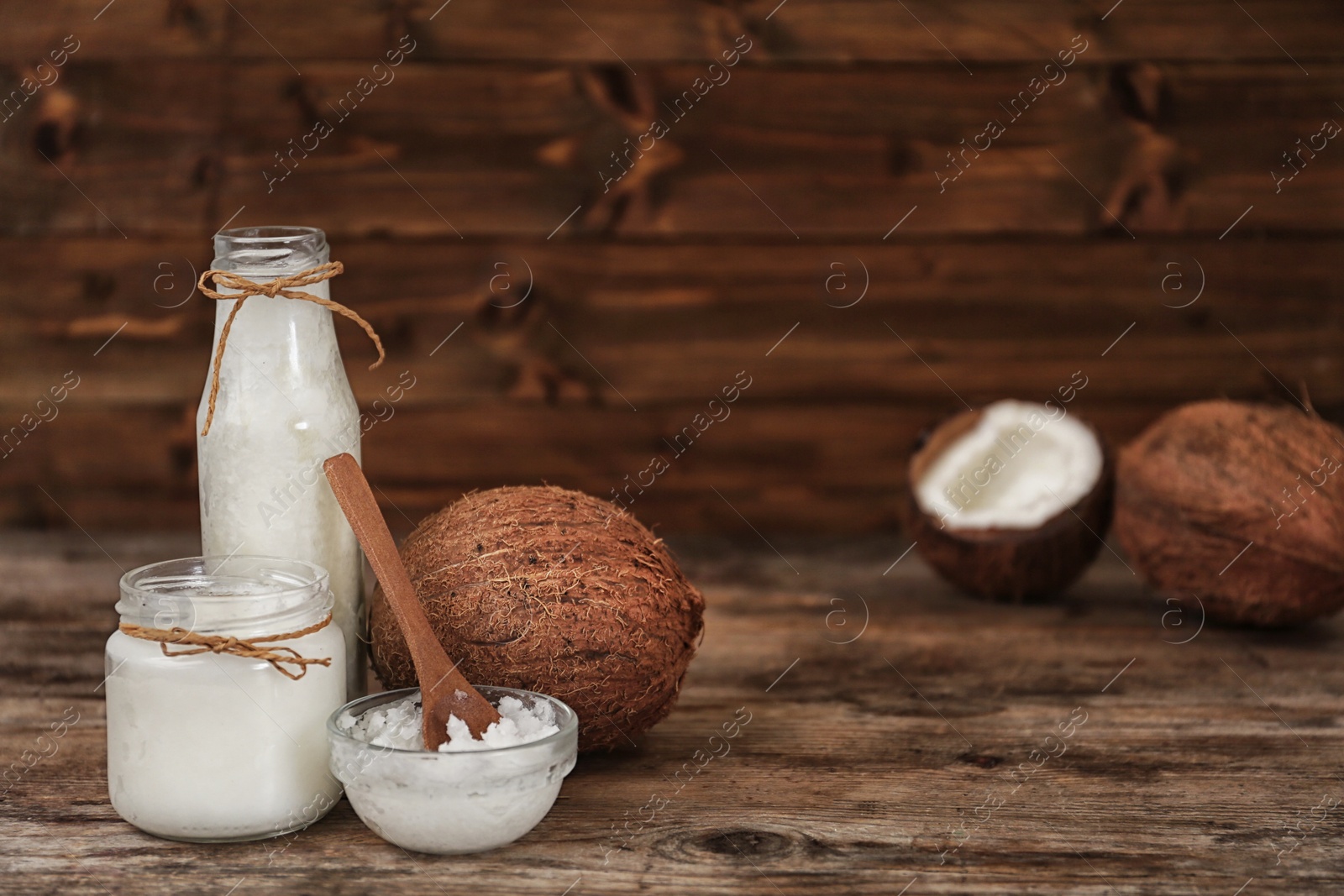 Photo of Fresh coconut oil on wooden table, space for text. Cooking ingredient