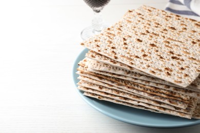 Photo of Plate with stack of matzos on white table