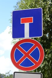 Photo of Different road signs on city street. Traffic rules