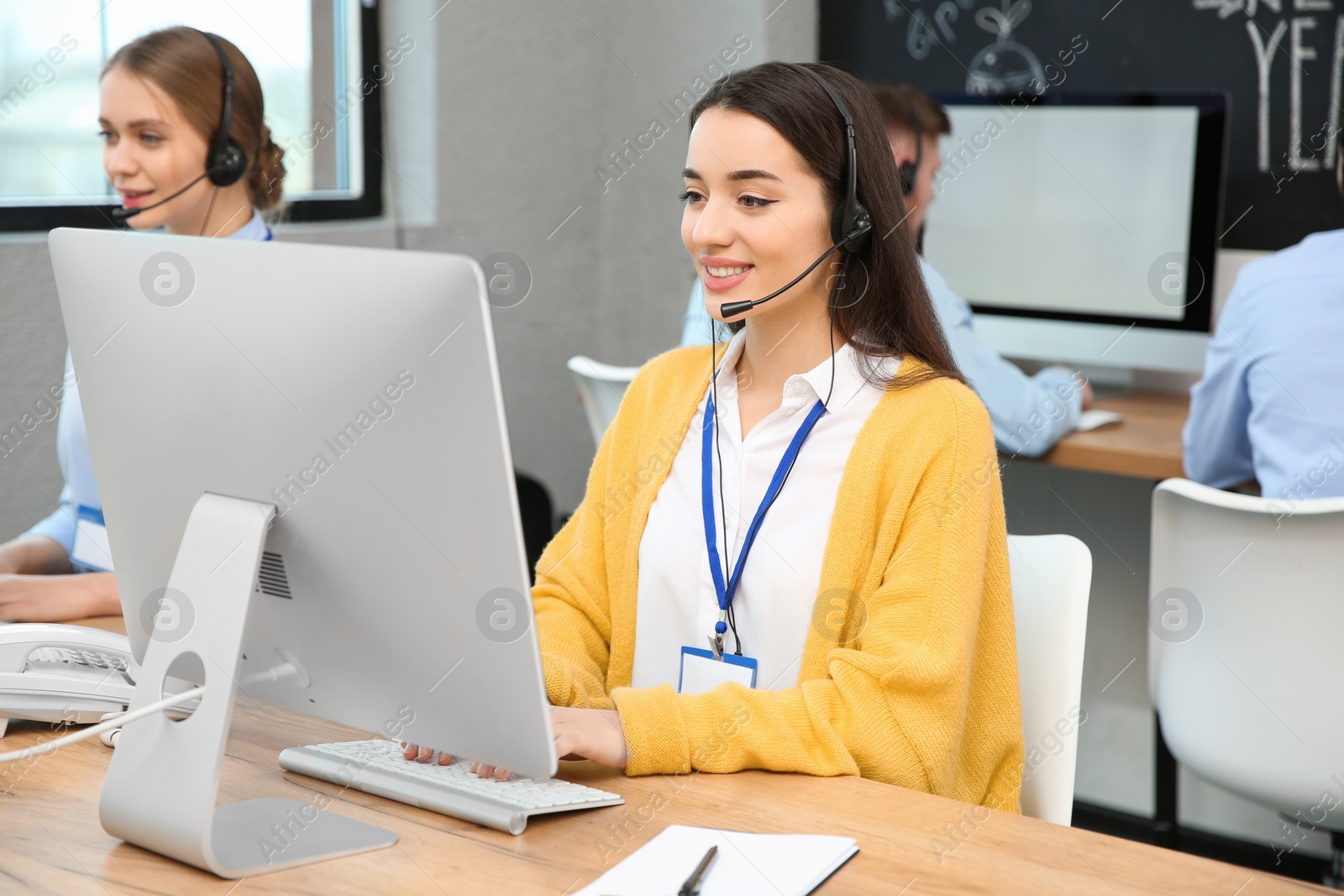 Photo of Technical support operator working with colleagues in office