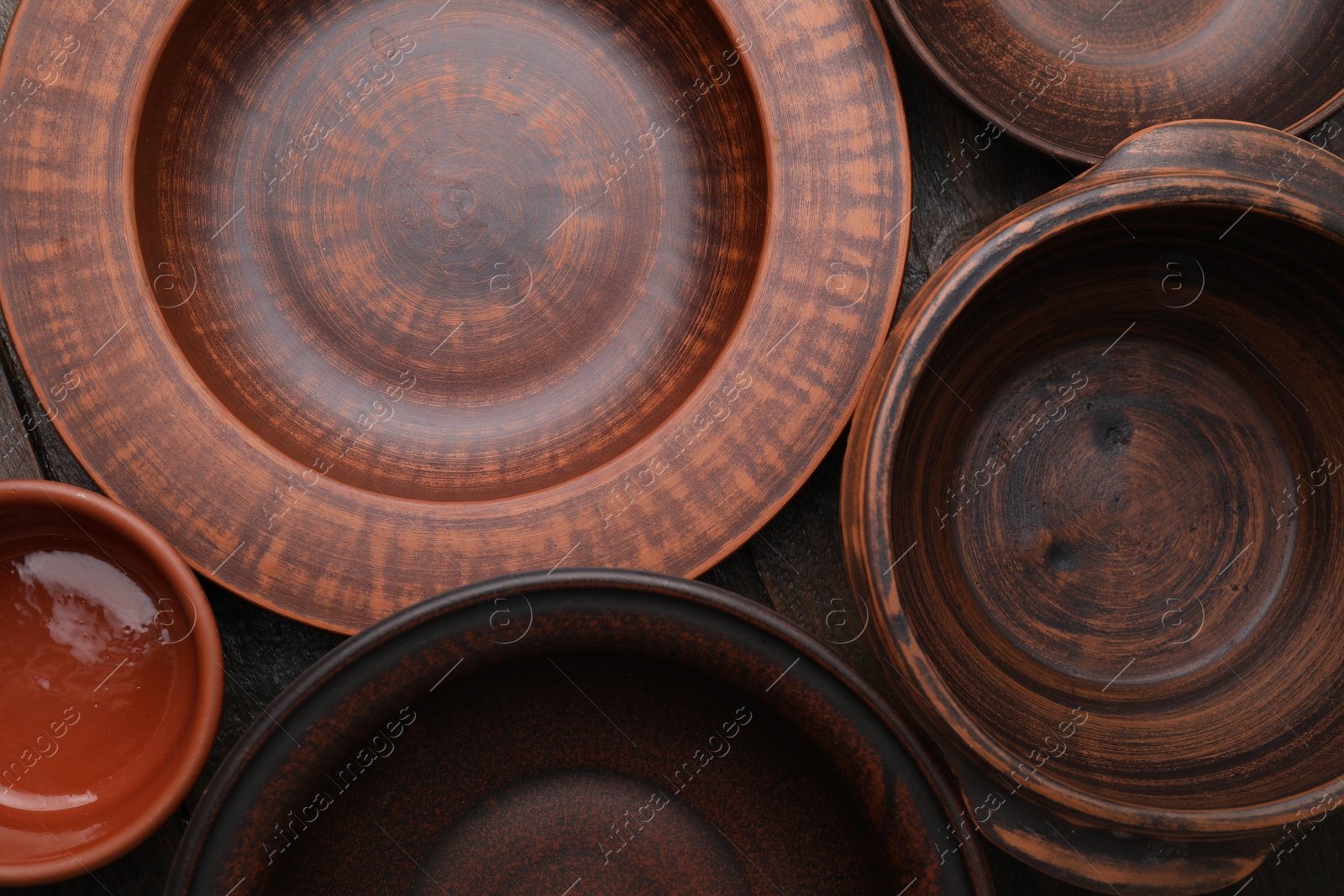 Photo of Set of clay dishes on table, flat lay. Cooking utensils