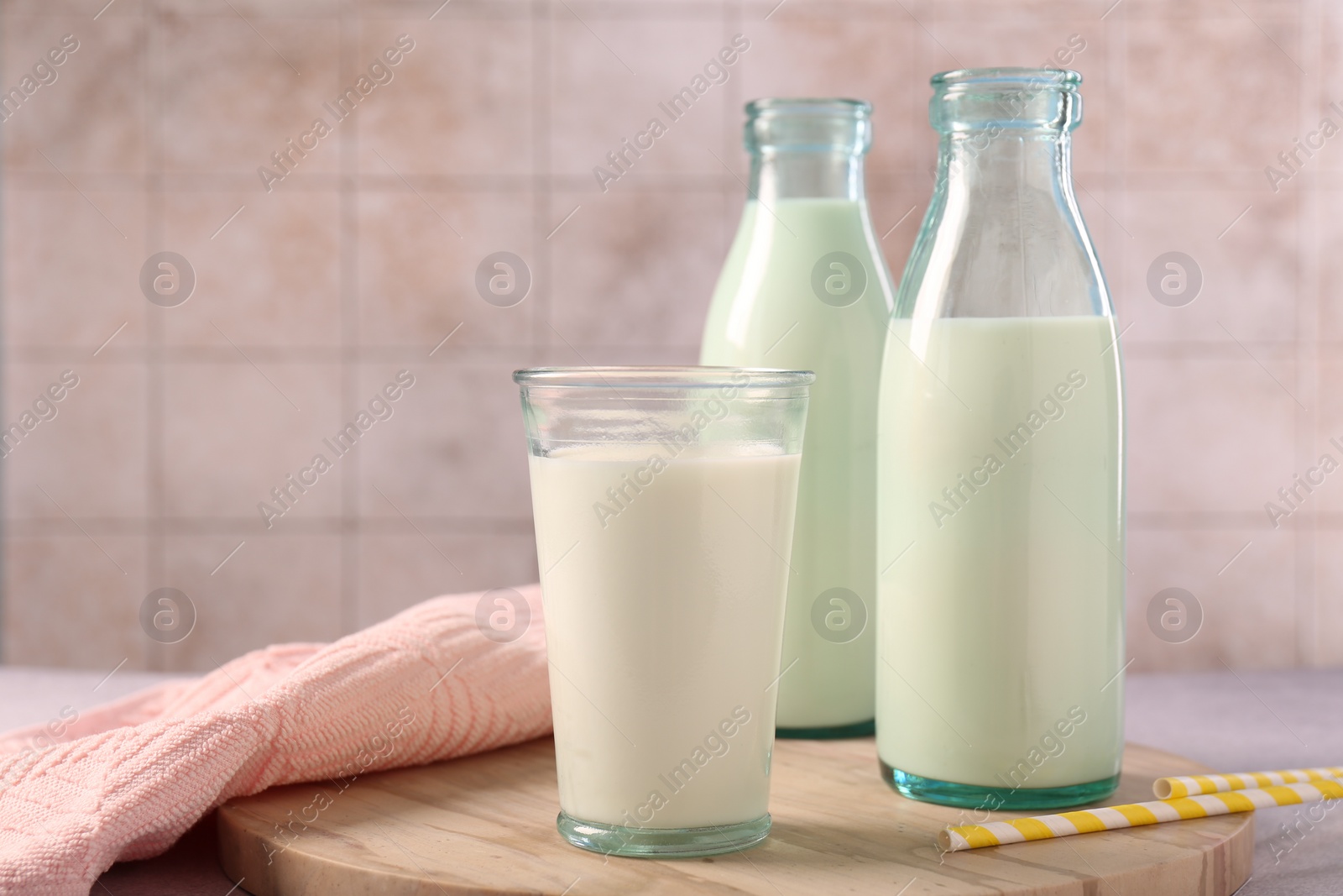 Photo of Glassware with tasty milk on table, space for text