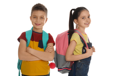 Little school children with backpacks on white background