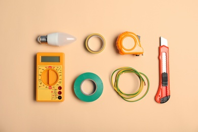 Flat lay composition with electrician's tools on color background