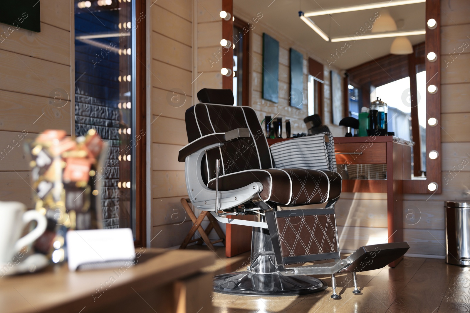 Photo of Stylish hairdresser's workplace with professional armchair in barbershop