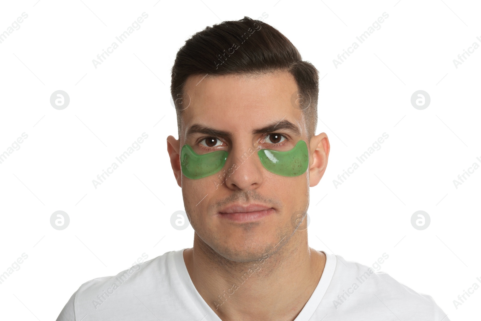 Photo of Man with green under eye patches on white background