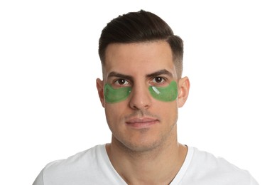 Man with green under eye patches on white background