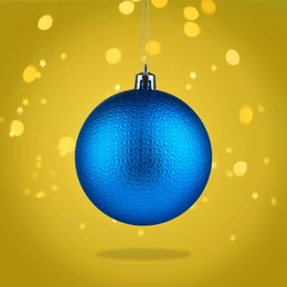 Image of Beautiful blue Christmas ball hanging on yellow background