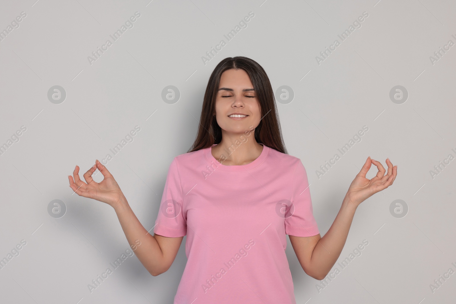 Photo of Young woman meditating on white background. Zen concept