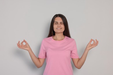 Photo of Young woman meditating on white background. Zen concept