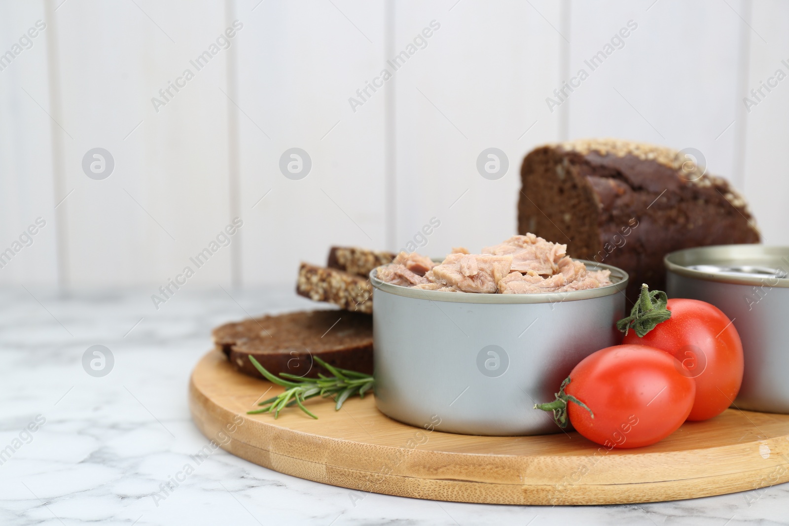 Photo of Composition with canned tuna on white marble table, space for text