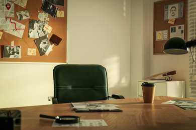 Photo of Detective workplace and evidence board in modern office