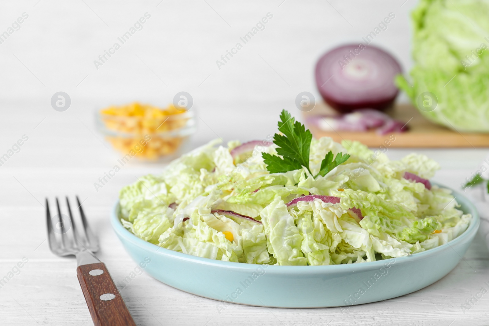 Photo of Fresh napa cabbage salad served on white table, closeup