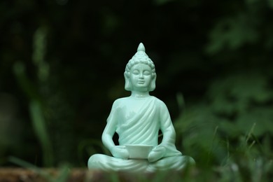 Photo of Beautiful decorative Buddha statue on blurred background outdoors