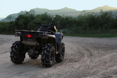 Photo of Modern fast quad bike on pathway outdoors