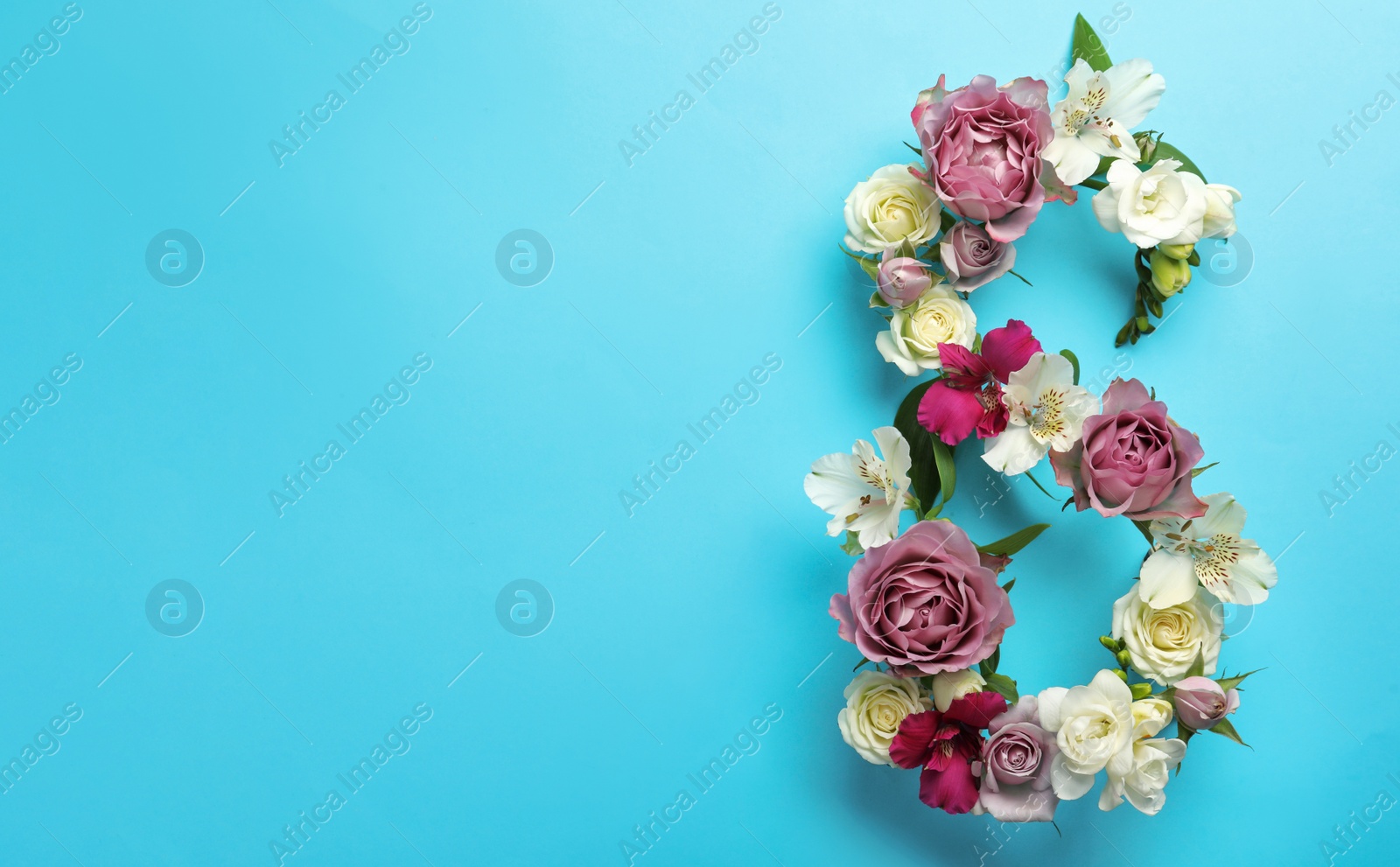 Photo of Number 8 made of beautiful flowers on light blue background, flat lay with space for text. International Women's day